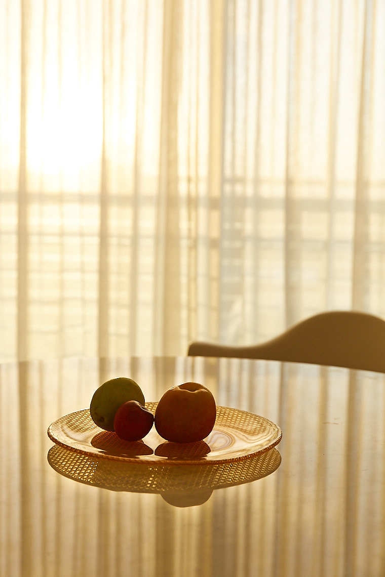 Commercial hotel photography of breakfast table with fruit and ocean backdrop