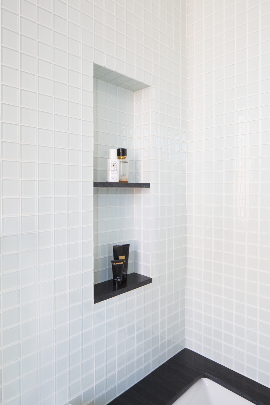 White tiled bathroom shower at Wettling Architects Haber