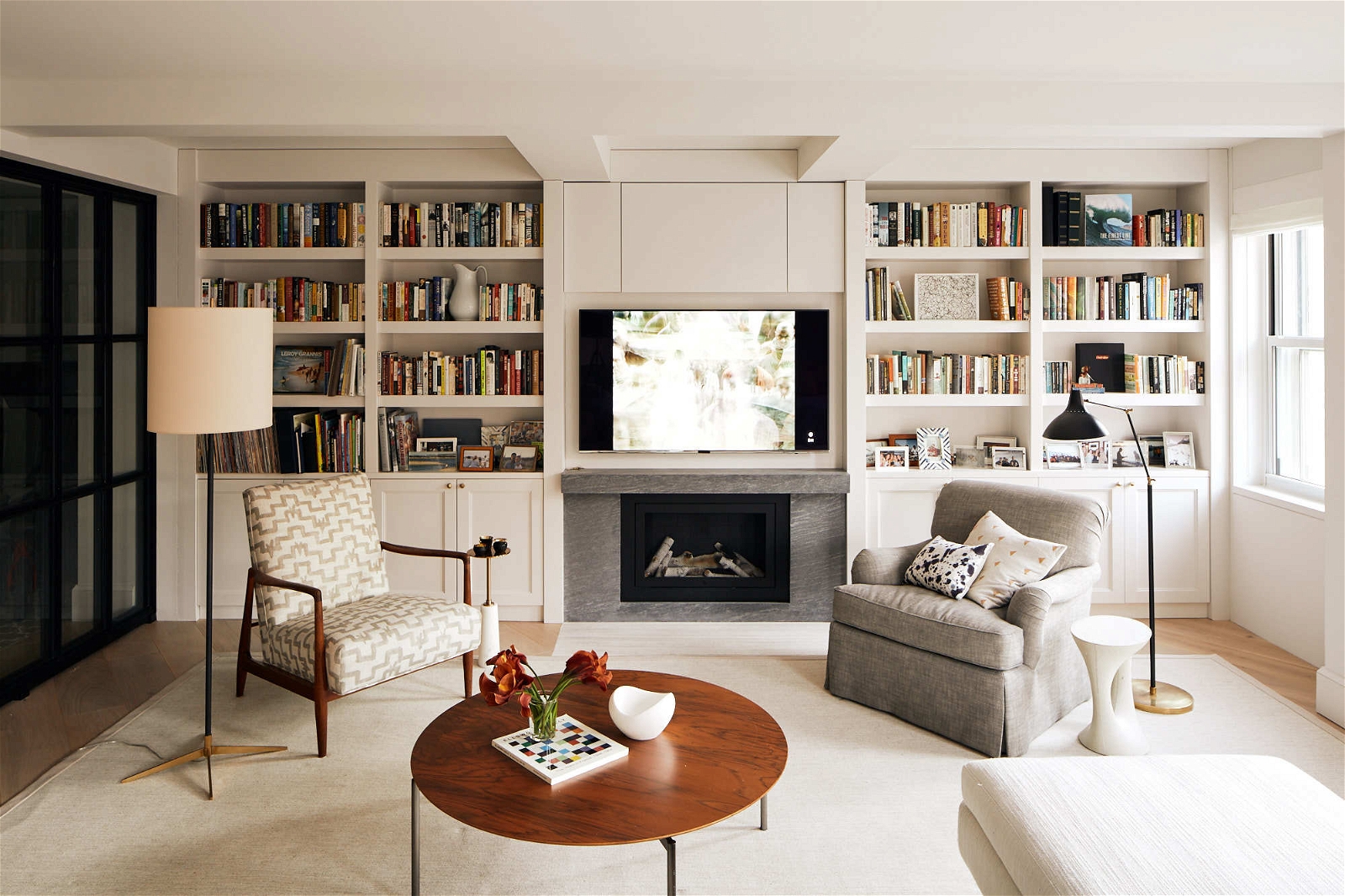 Cozy living room with big tv wooden coffee table and bookshelves
