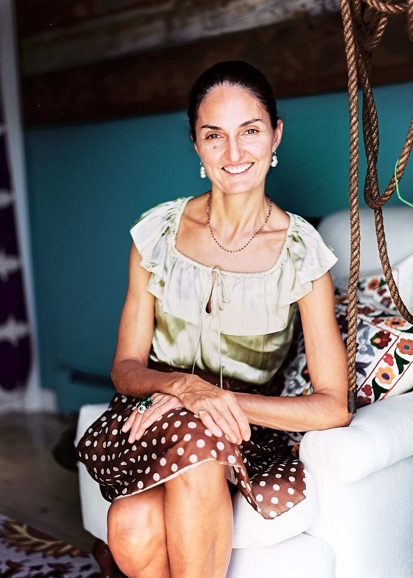 Woman in silk dress sitting and smiling