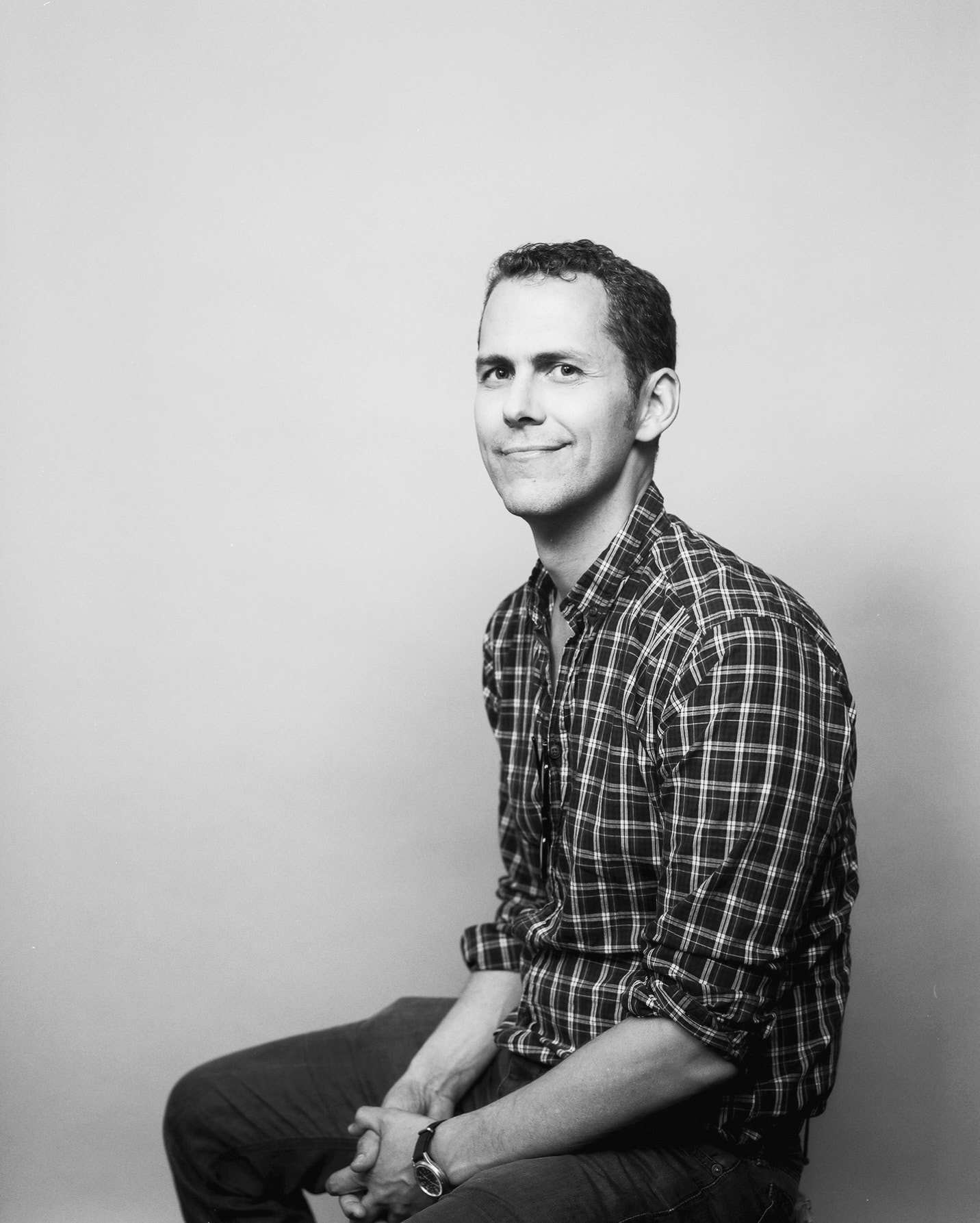 Black and white portrait of man in plaid