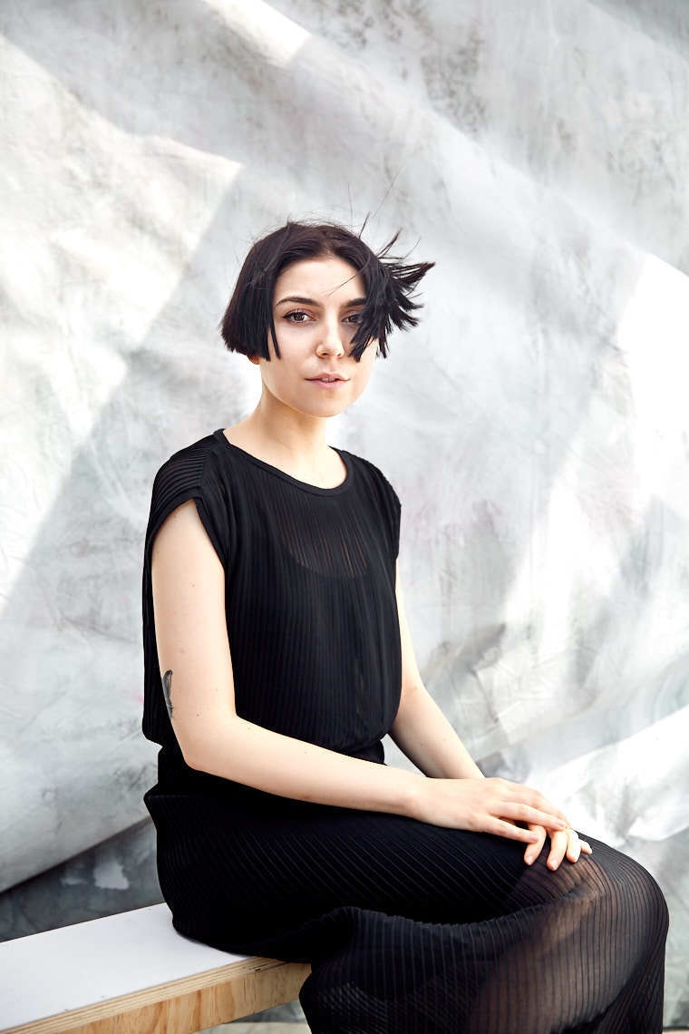 Editorial portrait of model with short black hair and black dress