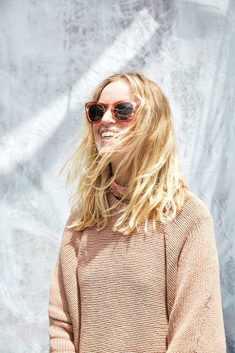West Coast Craft portrait of blonde girl in brown sunglasses and sweater