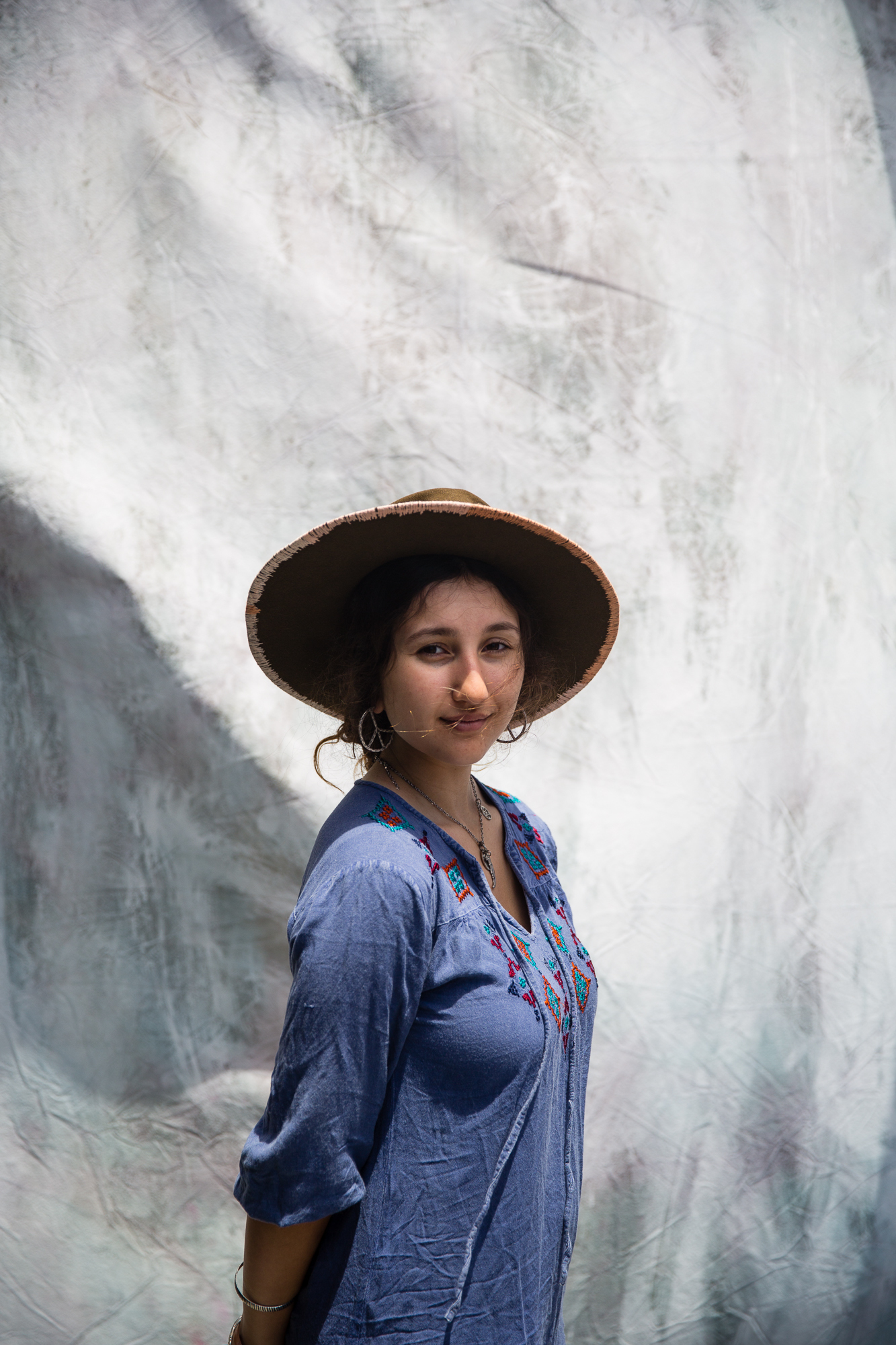 West Coast Craft portrait of girl in large brimmed hat and blue blouse