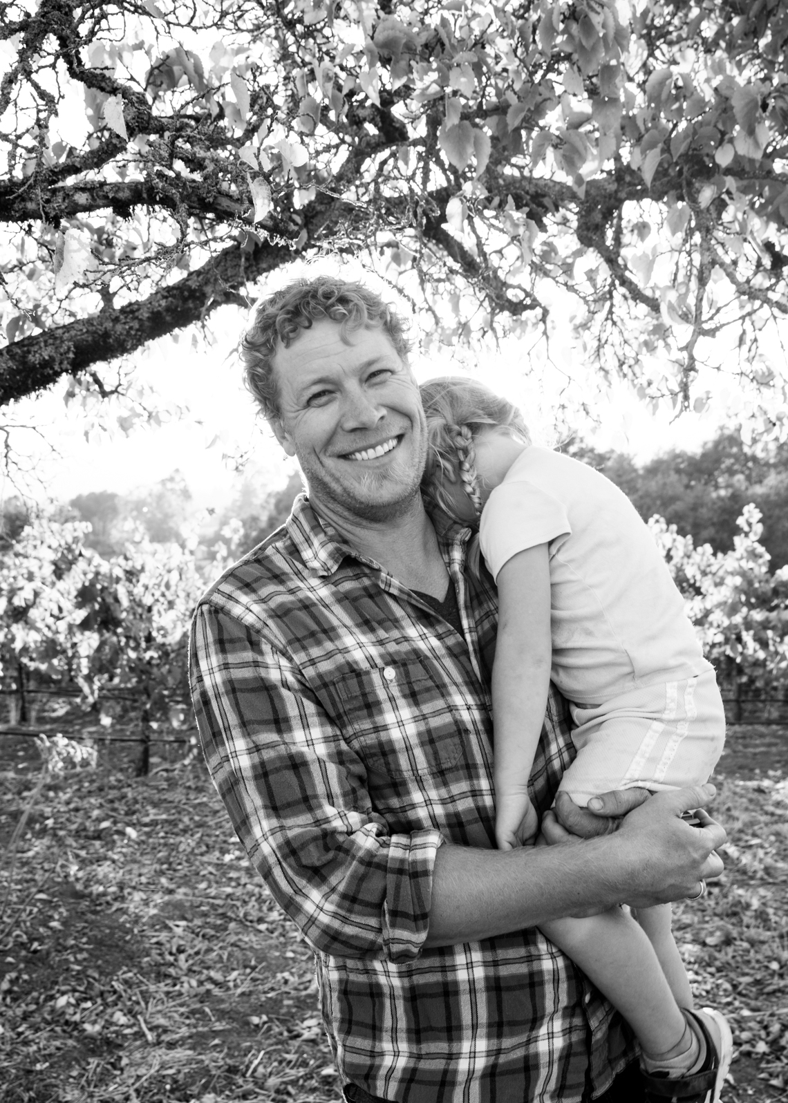 Food & Wine portrait of man in plaid smiling with young daughter