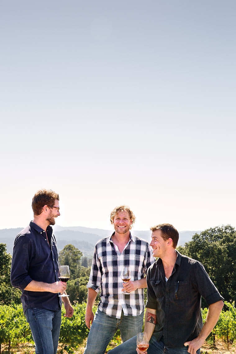 Food & Wine Bilbro Brothers smiling and drinking wine at vineyard