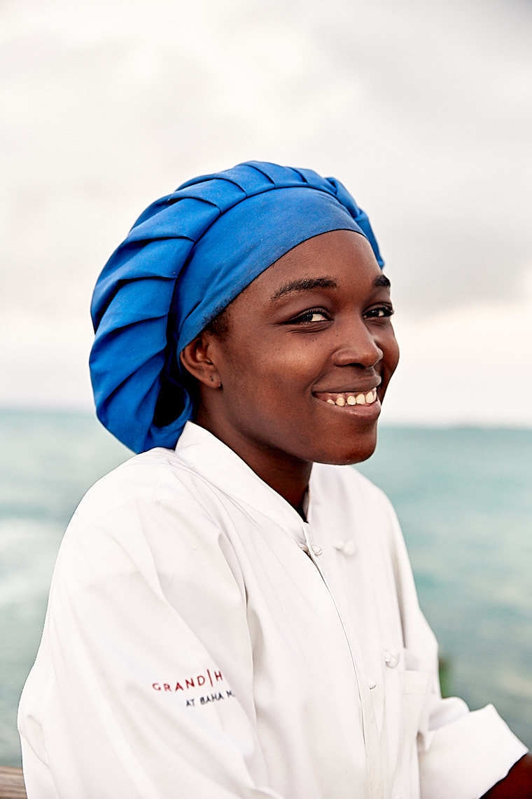 Woman at Grand Hyatt Baha Mar with blue chefs hat and white coat