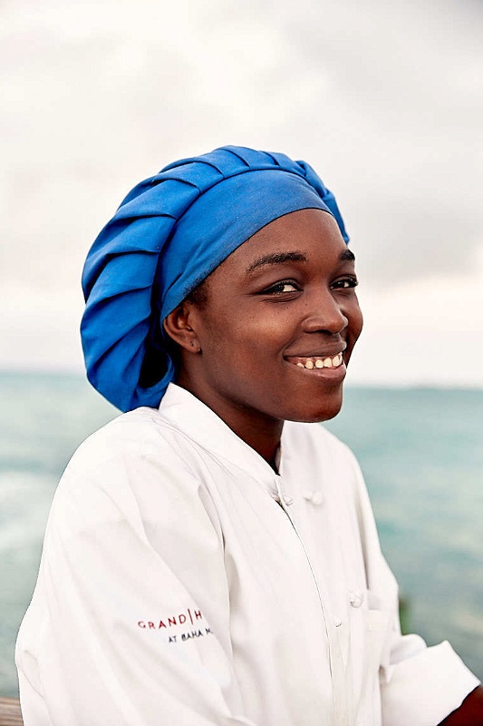 Woman at Grand Hyatt Baha Mar with blue chefs hat and white coat