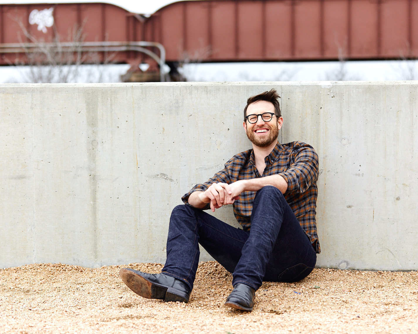 Happy man Jonathan Buck smiling in plaid button down shirt