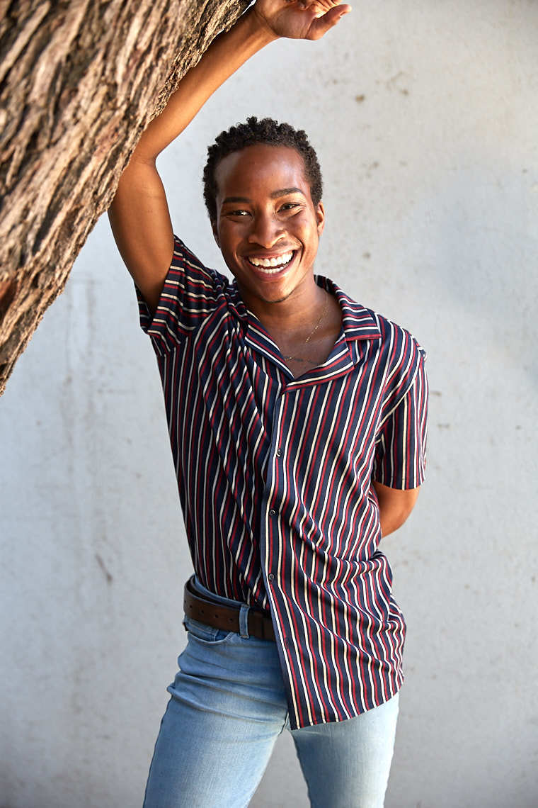 Ray Jones smiling in red white and blue striped button down shirt