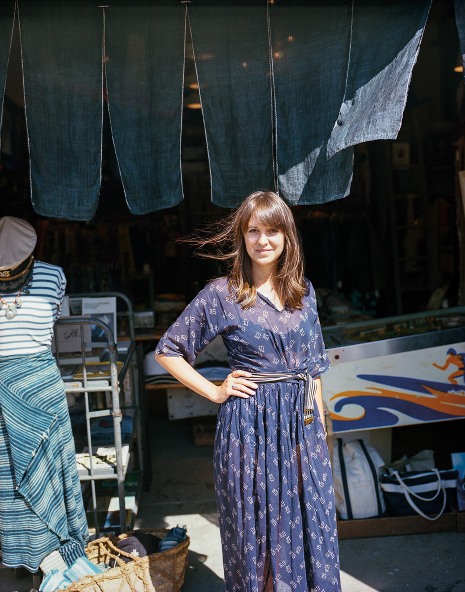 Portrait of a woman in navy dress at antique shop